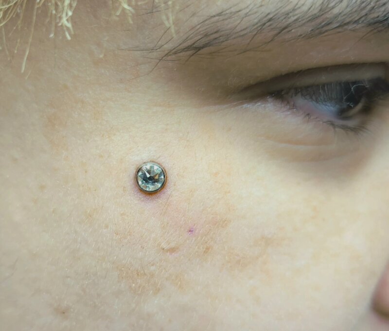 Cheek dermal piercing by Mindcrusher Tattoo, Rogers Park Chicago