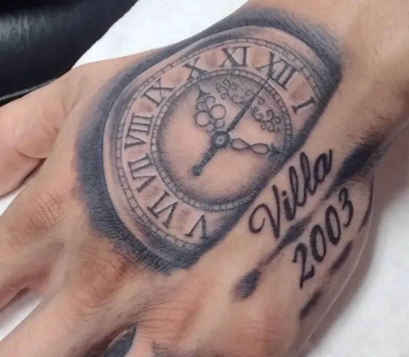 Clock and Roman numeral hand tattoo by Mindcrusher Tattoo, Rogers Park Chicago