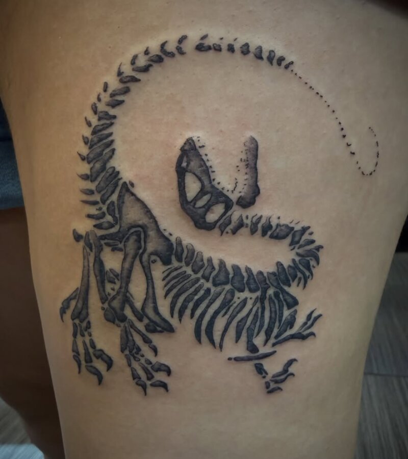 Blackwork dinosaur skeleton tattoo by Mindcrusher Tattoo, Rogers Park Chicago