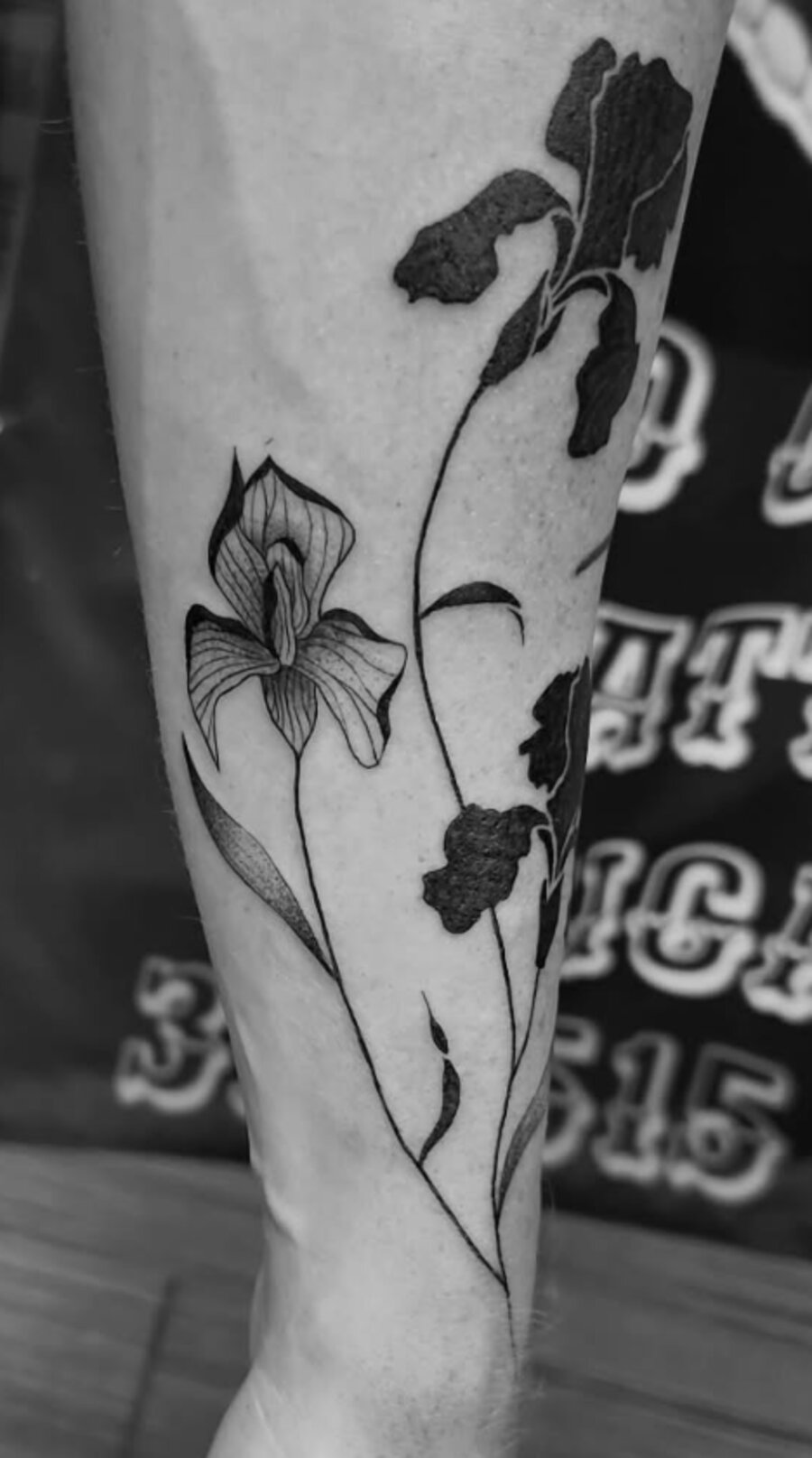 Fine line botanical iris tattoo done at Mindcrusher Tattoo, Rogers Park Chicago