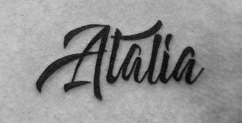 Cursive script lettering tattoo by Mindcrusher Tattoo, Rogers Park Chicago