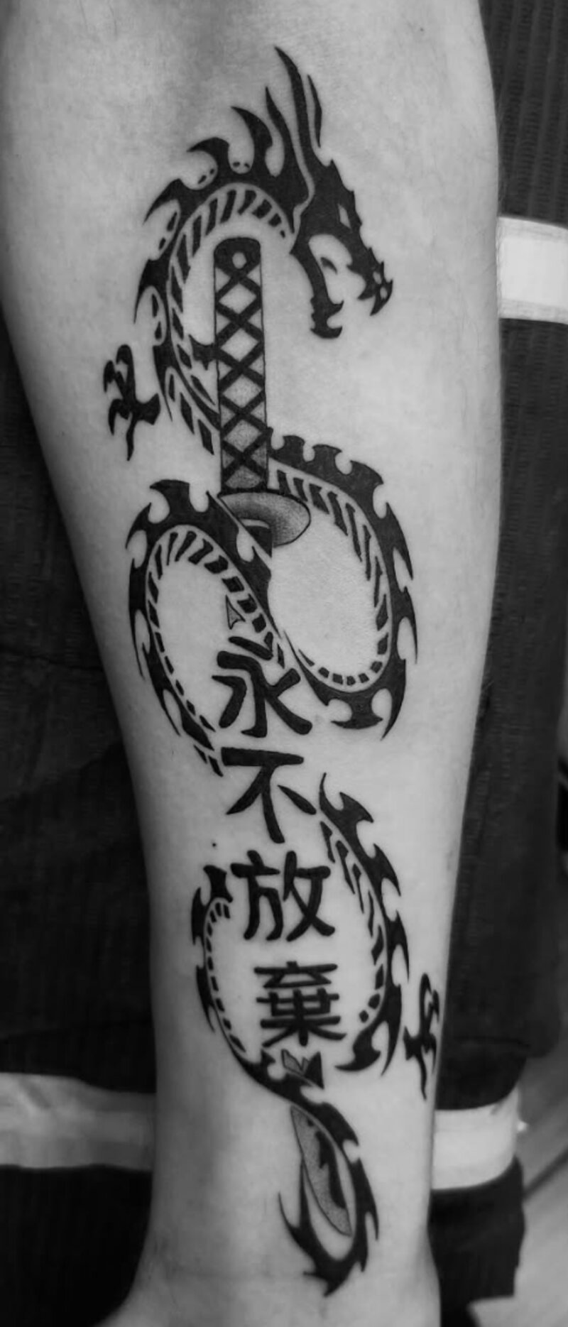 Tribal dragon blackwork tattoo by Mindcrusher Tattoo, Rogers Park Chicago